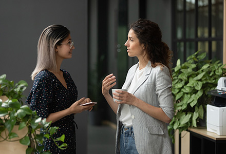 Two women in an office having a conversation