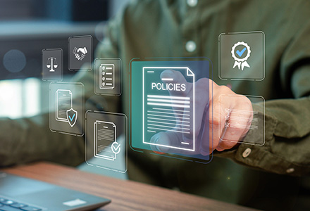 Businessman at a laptop reviewing a virtual online document with a dashboard of policies and checkboxes